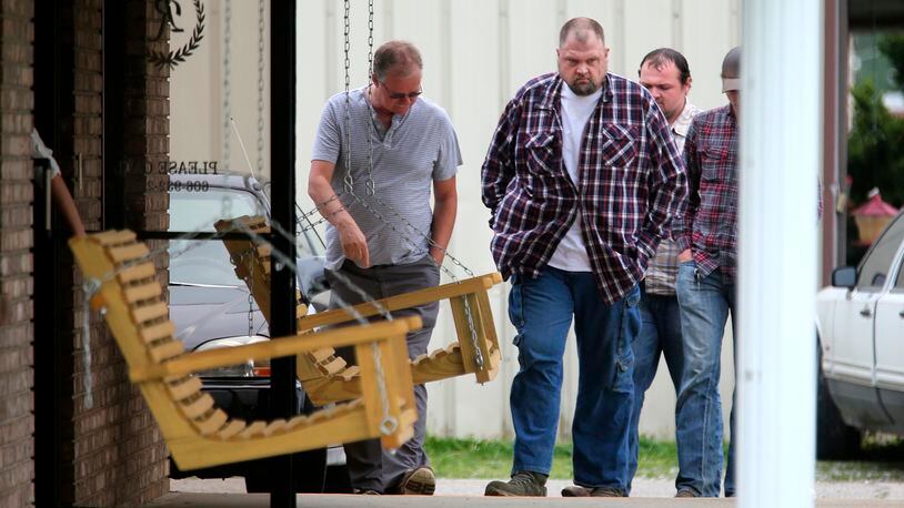 This April 27, 2016 photo,  George 'Billy' Wagner, center, and his son's George Wagner IV, in back and Jake Wagner, at right,  attend  the funeral of Gary Rhoden, 38, in Greenup, KY.  A custody dispute between two families that erupted into the massacre of eight people in rural southern Ohio started with a plan to kill just one of them, a young mother refusing to give up her daughter, a prosecutor said Monday, Oct. 4. 2022.  George Wagner IV faces the death penalty if he’s convicted in the slayings of the Rhoden family near Piketon. His younger brother, Jake Wagner, last year pleaded guilty to shooting five of the victims, and is expected to testify against his brother as part of a deal with prosecutors that spared him from being sentenced to death. (Liz Dufour/The Cincinnati Enquirer via AP)