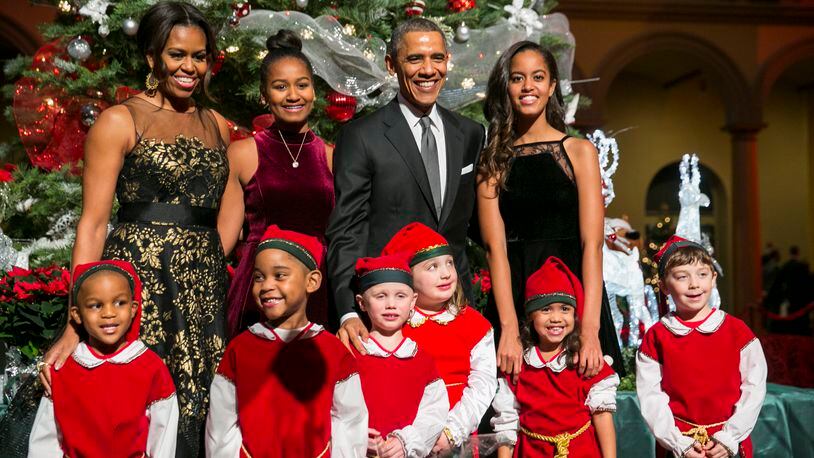 President Barack Obama, center right, first lady Michelle Obama, left, and daughters Sasha, center left, and Malia, right, pose with 'elves' prior to the taping of TNT's 'Christmas in Washington' program in Washington, D.C. on December 14, 2014. The family released their final White House Christmas cards in 2016. Photo Credit: Kristoffer Tripplaar/ Sipa USA (Photo by SIPA USA-KT/SIPA/WHITE HOUSE POOL (ISP POOL IMAGES)/Corbis/VCG via Getty Images)