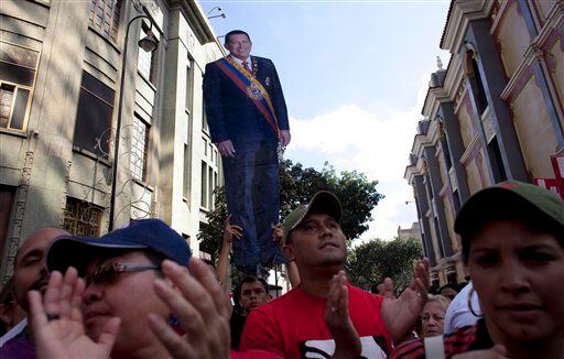 A life-size cut out image of Venezuela's President Hugo Chavez is carried by a Chavez supporter during a symbolic inauguration ceremony.