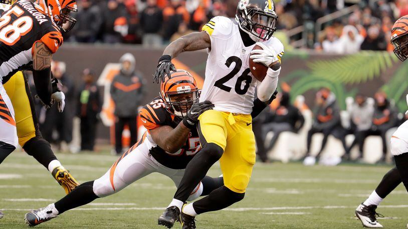 Vontaze Burfict #55 of the Cincinnati Bengals attempts to tackle Le’Veon Bell #26 of the Pittsburgh Steelers during the third quarter at Paul Brown Stadium on December 18, 2016 in Cincinnati, Ohio. (Photo by Andy Lyons/Getty Images)