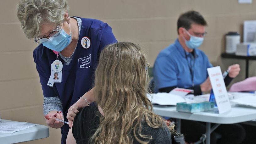 A patient gets her COVID booster shot at the Clark County Combined Health District's Vaccine Center last month. BILL LACKEY/STAFF