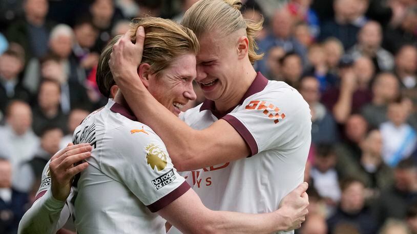 Manchester City's Kevin De Bruyne, centre, celebrates with Jack Grealish, left, and Erling Haaland after scoring his side's fourth goal during the English Premier League soccer match between Crystal Palace and Manchester City at Selhurst Park stadium in London, Saturday, April 6, 2024.(AP Photo/Frank Augstein)