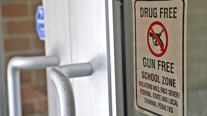 A sign telling everyone entering Fulton Elementary that it's a gun and drug free zone is displayed on the front door Wednesday, August 3, 2022. BILL LACKEY/STAFF