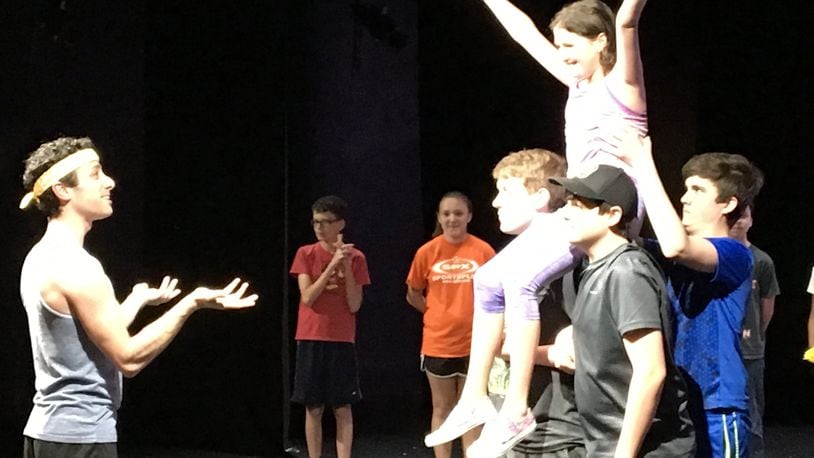 Choreographer Paul Smith (left) gives feedback to Evie Oehlers as Annie (with arms raised) and the ensemble during Monday’s rehearsal for the Youth Arts’ Ambassadors’ musical production of “Annie, Jr.” CONTRIBUTED