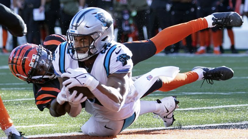 Carolina Panthers tight end Tommy Tremble (82) makes a touchdown catch as Cincinnati Bengals safety Dax Hill (23) defends during the second half of an NFL football game, Sunday, Nov. 6, 2022, in Cincinnati. (AP Photo/Joshua A. Bickel)