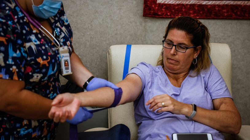 Nancy Gillespie, from Dayton, donates blood Monday, June 28, 2021, at the Community Blood Center near downtown Dayton. JIM NOELKER/STAFF