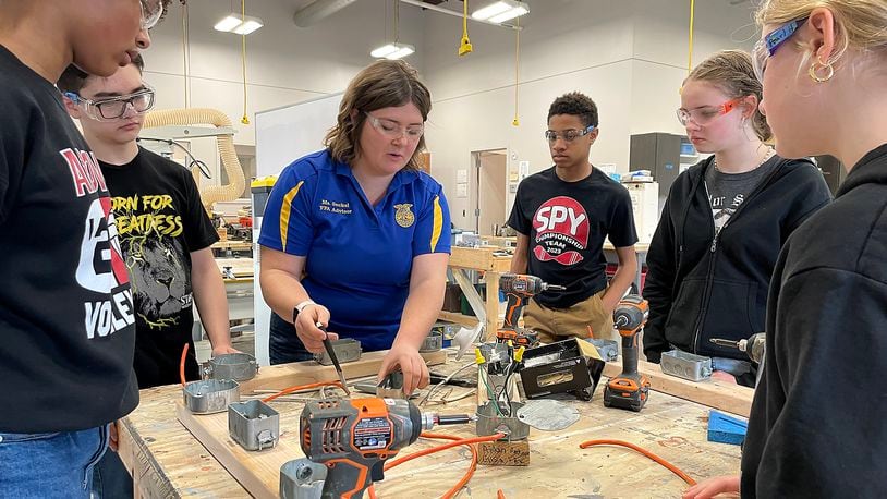 Trisha Seckel, an Ag teacher at the Global Impact STEM Academy, teaches a group of students basic electrical wiring techniques during a class Friday, March 8, 2024. BILL LACKEY/STAFF