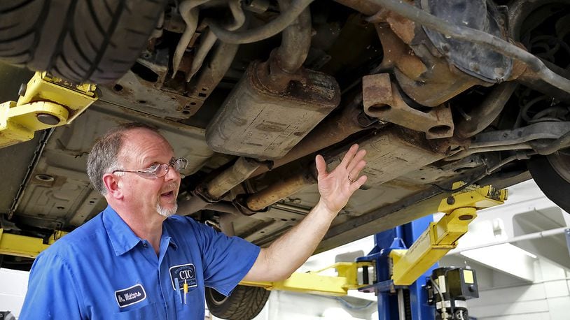 Stephen Walters, a teacher at Springfield/Clark Career Technical Center, explains what is wrong with a car in his lab. Walters is one of the four teachers of the year.