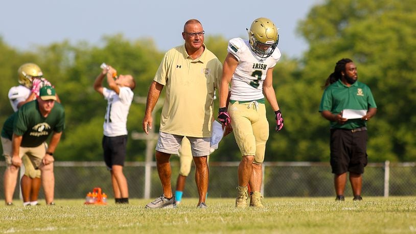 Catholic Central High School coach Jim Dimitroff talks with Ashton Young during their scrimmage game at Bradford last season. Dimitroff, a 1975 Central grad, was recently named the Irish's head football coach. CONTRIBUTED PHOTO BY MICHAEL COOPER