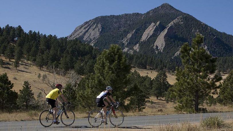 BOULDER, CO - 2009:  Two bicyclists peddle up Table Mesa Road with the Flatiron rock formation as a backdrop as seen in this 2009 Boulder, Colorado, spring landscape photo. (Photo by George Rose/Getty Images)