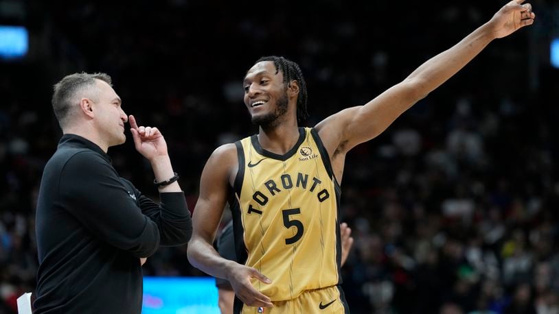 Toronto Raptors guard Immanuel Quickley (5) speaks with his head coach Darko Rajakovic, left, during second-half NBA basketball game action in Toronto, Sunday, April 7, 2024. (Frank Gunn/The Canadian Press via AP)