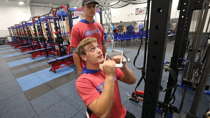 Nathan Snyder, seated, and Jake Suman try out the new workout equipment in the new athletic complex at Northwestern Schools Thursday evening. The new multi-million dollar complex was officially opened Thursday evening during a reception and open house. BILL LACKEY/STAFF