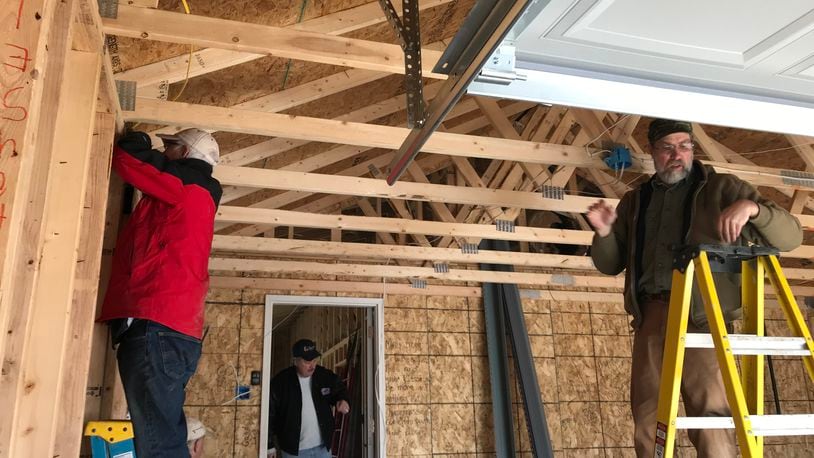Clark County Fuller Center for Housing volunteers (left to right) Bruce Pratte, John Grubb and Ray Raber work inside the garage of new home build in February of 2018. The Fuller Center is merging with Habitat for Humanity of Greater Dayton on Feb. 15, maintaining a local office and local staff while creating opportunities to serve more Clark County low-income families. Contributed photo