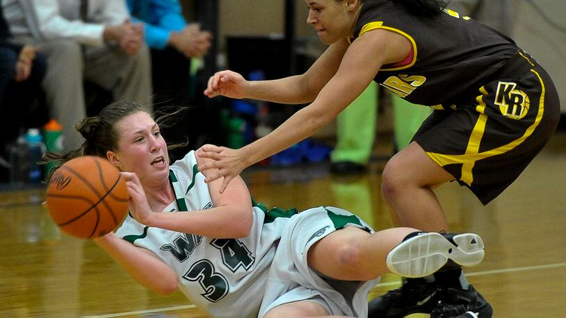 Greenville's Megan Galloway tries to get rid of the ball after recovering it under pressure from Kenton Ridge's Aianna Wilson during Wednesday's tournament game at Tecumseh. Bill Lackey/Staff