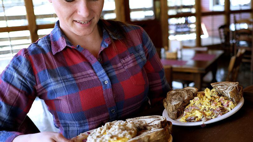 Sara Williams serves up a customer’s order with a smile at Clifton Mill. Bill Lackey/Staff