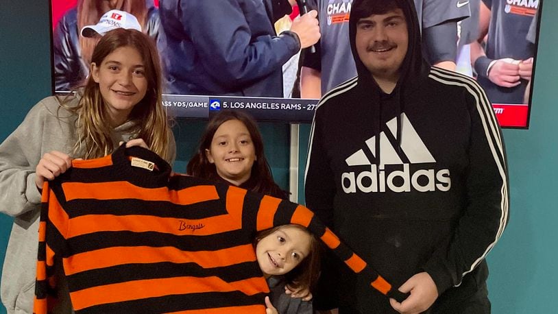 Mike Leo's grandkids hold his Bengals sweater after the Bengals beat the Chiefs on Sunday in the AFC Championship game. Pictured are: Madison Leo, 14; Joslyn Leo, 10; Kensington Leo, 8; and Austin Leo, 16. Photo courtesy of Scott Leo