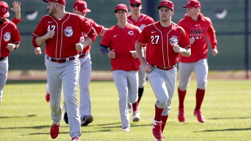Cincinnati Reds baseball players run drills during the teams’ first spring training workout, Saturday, Feb. 15, 2020, in Goodyear, Ariz. (AP Photo/Matt York)