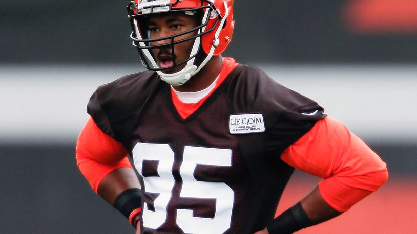 FILE - In this May 12, 2017, file photo, Cleveland Browns’ Myles Garrett listens to his coaches during NFL football rookie minicamp, in Berea, Ohio. Myles Garrett limped off the field Wednesday, June 14, 2017 a scary sight for the Cleveland Browns. The No. 1 overall draft pick sustained an injury to his left foot late in practice while rushing quarterback Brock Osweiler during a two-minute drill. (AP Photo/Ron Schwane, File)