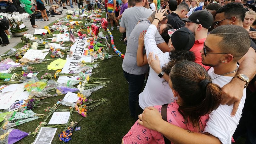 061316 ORLANDO: A group of friends who lost best friends Amanda Alvear and Mercedez Flores console each other at a vigil for family and friends that have lost loved ones, drawing thousands outside the Dr. Phillips Center for the Performing Arts Center in Orlando, Fla., Monday, June 13, 2016. Curtis Compton / ccompton@ajc.com