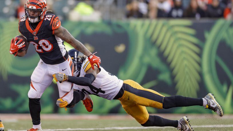 CINCINNATI, OH - NOVEMBER 24: Joe Mixon #28 of the Cincinnati Bengals runs the ball during the second half as Terrell Edmunds #34 of the Pittsburgh Steelers hangs for the tackle at Paul Brown Stadium on November 24, 2019 in Cincinnati, Ohio. (Photo by Michael Hickey/Getty Images)