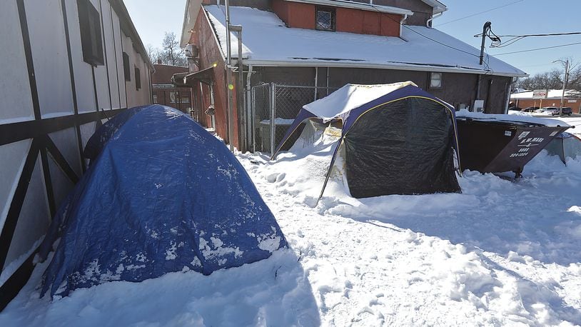 The tents in a homeless encampment, located behind to Springfield Soup Kitchen, were covered in snow in january. There is an effort to get two congregant shelters in the city back online. BILL LACKEY/STAFF