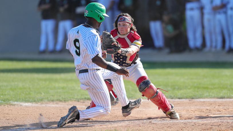 Kenton Ridge High School senior catcher Keller Fultz tags out Hamilton Badin senior Rodney Rachel at the plate during their Division II district final game on Thursday evening at Arcanum High School. The Rams won 10-0 in five innings. CONTRIBUTED PHOTO BY MICHAEL COOPER