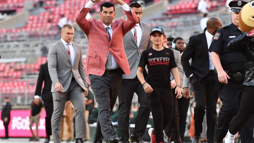 COLUMBUS, OH - OCTOBER 5: Head Coach Ryan Day of the Ohio State Buckeyes salutes fans with an “O” as he walks through Ohio Stadium before a game against the Michigan State Spartans on October 5, 2019 in Columbus, Ohio. (Photo by Jamie Sabau/Getty Images)