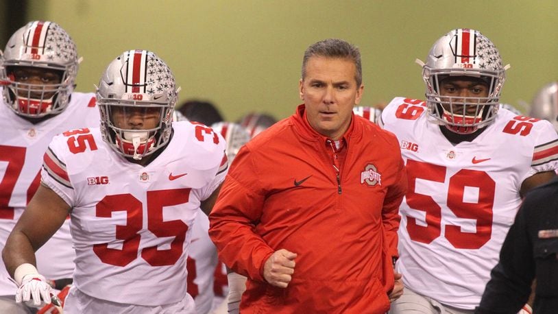 Ohio State’s Urban Meyer leads the team onto the field before a game against Wisconsin on Dec. 2, 2017, at Lucas Oil Stadium in Indianapolis. David Jablonski/Staff