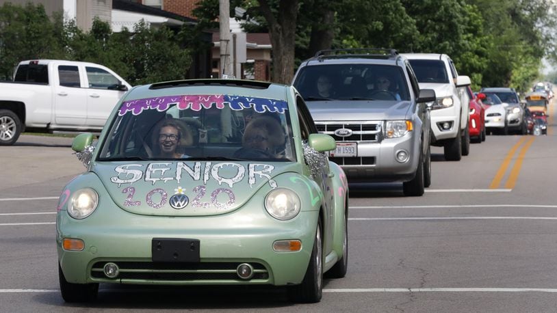Graduating seniors at Graham High School participate in a graduation parade through St. Paris in May. The seniors were led by a Champaign County Sheriff's cruiser as they traveled from St. Paris to Christiansburg and around to all the small towns in the school district. BILL LACKEY/STAFF