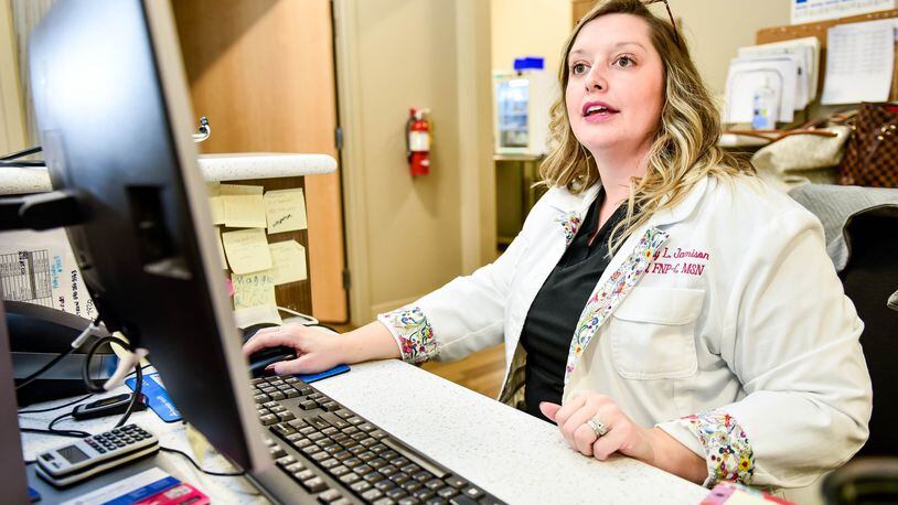 Family Nurse Practitioner Brittany Jamison works at the computer between seeing patients at Premier Health Urgent Care on N. Main Street in Springboro Wednesday, Feb. 29, 2020. NICK GRAHAM / STAFF