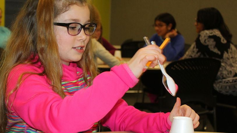 Kacie Petticrew, a fifth grade student at Snyder Park Elementary School, takes part in a GIRLS IN STEM workshop. JEFF GUERINI/STAFF
