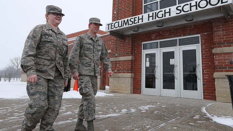 Tecumseh ROTC Cadet TSgt Harley Adamson and Cadet Major Matthew Lindamood walk past one of the entrances to Tecumseh High School Friday. Tecumseh ROTC is hosting an event next week honoring veterans of the Batan Death March and would like the community to come. Bill Lackey/Staff