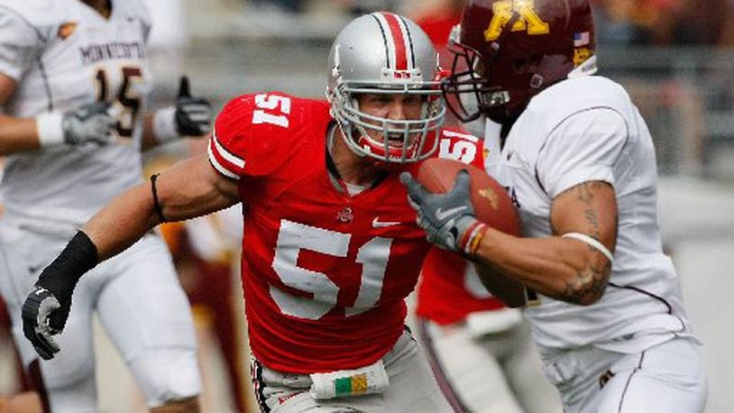 Ohio State's Ross Homan, 51, goes after Minnesota's Eric Decker, 7, in the second half of their game at The Ohio Stadium, September 27, 2008. (Dispatch photo by Neal C. Lauron)