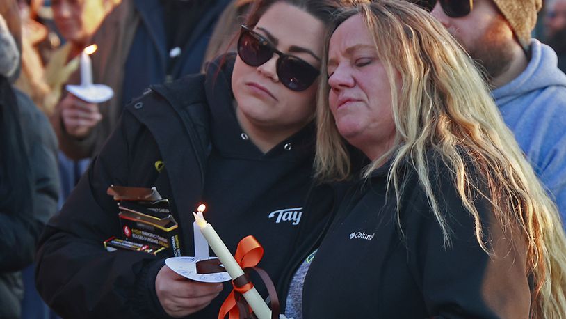 Family, friends and community members fill the parking lot of Gill's Quality Meat Market Monday, Jan. 9, 2023 during a candle light vigil for Thomas Gill, who was shot and killed last Thursday while driving his SUV in Springfield. 