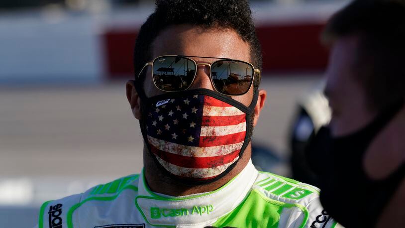 Bubba Wallace speaks to crew before a NASCAR Cup Series auto race Sunday, Sept. 6, 2020, in Darlington, S.C. (AP Photo/Chris Carlson)