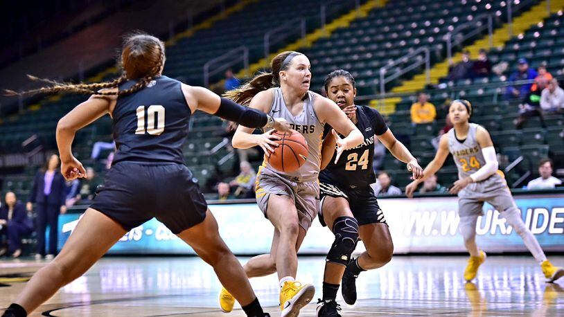 Wright State guard Mackenzie Taylor drives through the Oakland defense Friday night at the Nutter Center. Joseph Craven/CONTRIBUTED