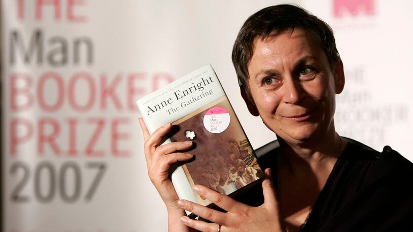 FILE - Irish writer Anne Enright holds a copy of her book after she won the Man Booker fiction prize for "The Gathering," an uncompromising portrait of a troubled family that its author called the literary equivalent of a Hollywood weepie, in London on Oct. 16 2007. Novels that give voice to the often unheard stories of migrants around the world are among the nominees for the 2024 Women’s Prize for Fiction. The 16-book long list announced Tuesday, April 24, 2024, for the 30,000 pound ($38,000) award includes works by writers from Ghana, Barbados, Britain, the United States, Ireland, South Korea and Australia. (AP Photo/Alastair Grant, File)