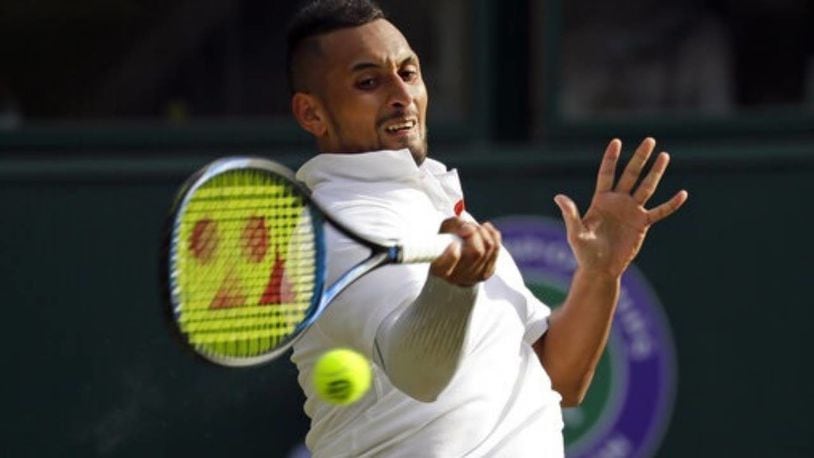 Nick Kyrgios returns a shot against Rafael Nadal during their second-round match at Wimbledon on Thursday.
