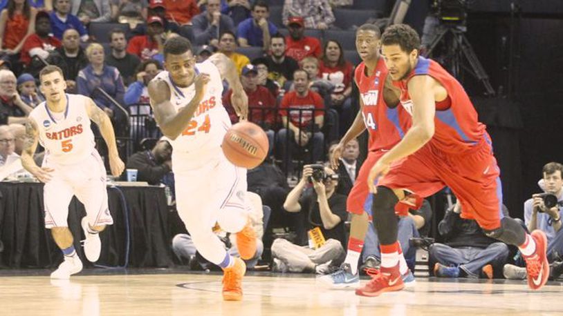Dayton's Devin Oliver, right, and Florida's Casey Prather chase a loose ball in the Elite Eight on Saturday, March 29, 2014, at FedExForum in Memphis, Tenn.