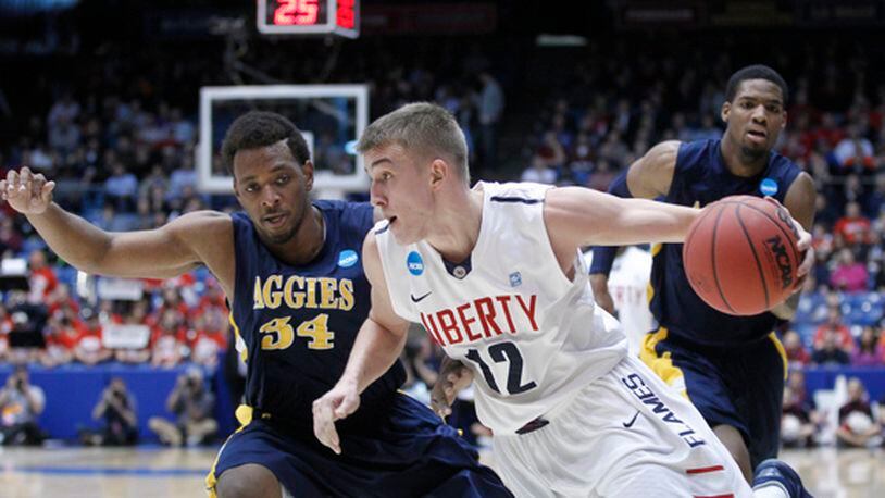 Tomasz Gielo (12) of Liberty is guarded by Bruce Beckford (34) of North Carolina A&T during the NCAA tournament First Four basketball games at University of Dayton Arena on March 19, 2013. Barbara J. Perenic/Staff