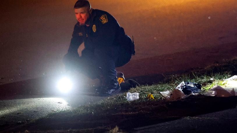 The Springfield Police Division investigates the scene of a shooting along the 600 block of Euclid Avenue Thursday evening, Dec. 21, 2023. According to police they arrived to find a male laying beside the road with a gunshot wound to the head. BILL LACKEY/STAFF