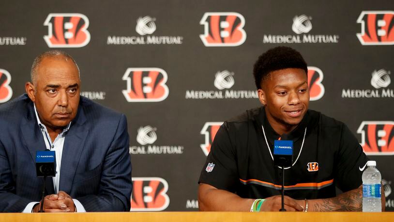 Cincinnati Bengals second-round draft pick Joe Mixon, right, is interviewed alongside head coach Marvin Lewis, left, during a news conference at Paul Brown Stadium, Saturday, April 29, 2017, in Cincinnati. The former Oklahoma running back was selected as the 48th overall pick. (AP Photo/John Minchillo)