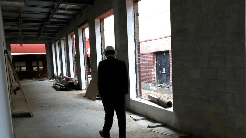 Greenon Local Schools' superintendent walks through construction on the district's new combined school building in October. The new school is slated to open in mid-2021. BILL LACKEY/STAFF