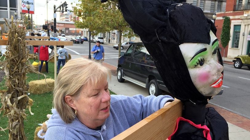 Sherry Ringler attaches the “Wicked Queen” to a wooden frame as she helps set-up for Project Jericho’s annual Project Scare-A-Crow contest in downtown Springfield in 2014. Bill Lackey/Staff