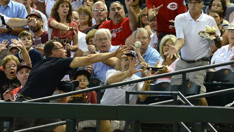 PHOENIX, AZ - JUNE 23: Fans try to catch a foul ball during a game between the Arizona Diamondbacks and the Cincinnati Reds at Chase Field on June 23, 2013 in Phoenix, Arizona. (Photo by Norm Hall/Getty Images)