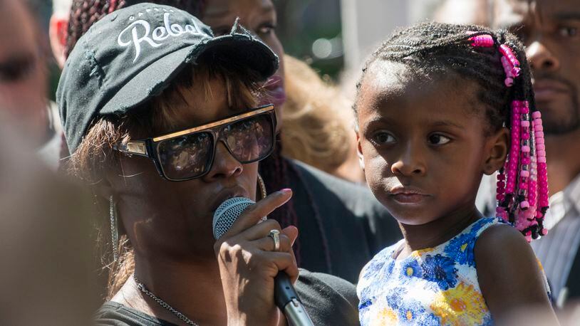 ST. PAUL, MN - JULY 07: Diamond Reynolds, holding her daughter, speaks to a crowd outside the Governor's Mansion on July 7, 2016 in St. Paul, Minnesota. Reynolds live streamed video of her boyfriend Philando Castile after he was shot by a police officer on the night of July 6th, 2016. (Photo by Stephen Maturen/Getty Images)