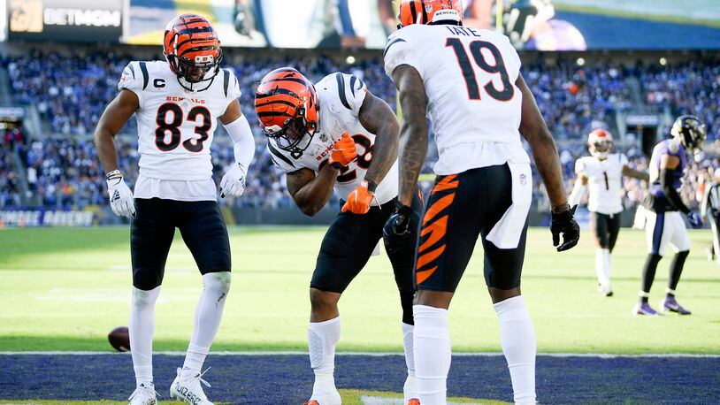 Cincinnati Bengals running back Joe Mixon, center, celebrates his touchdown run with wide receiver Tyler Boyd (83) and wide receiver Auden Tate (19) during the second half of an NFL football game against the Baltimore Ravens, Sunday, Oct. 24, 2021, in Baltimore. (AP Photo/Nick Wass)