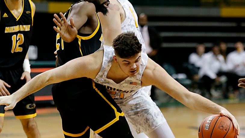 Wright State forward Grant Basile tries to drive on Milwaukee forward Tafari Simms during a Horizon League quarterfinal at the Nutter Center in Fairborn Mar. 2, 2021. Wright State lost 94-92. E.L. Hubbard/CONTRIBUTED