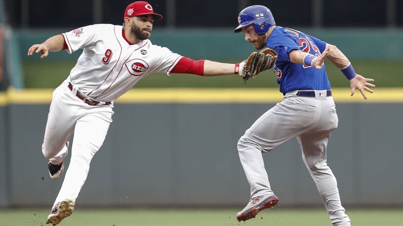 CINCINNATI, OH - AUGUST 08: José Peraza #9 of the Cincinnati Reds tags out Jonathan Lucroy #25 of the Chicago Cubs at Great American Ball Park on August 8, 2019 in Cincinnati, Ohio. (Photo by Michael Hickey/Getty Images)
