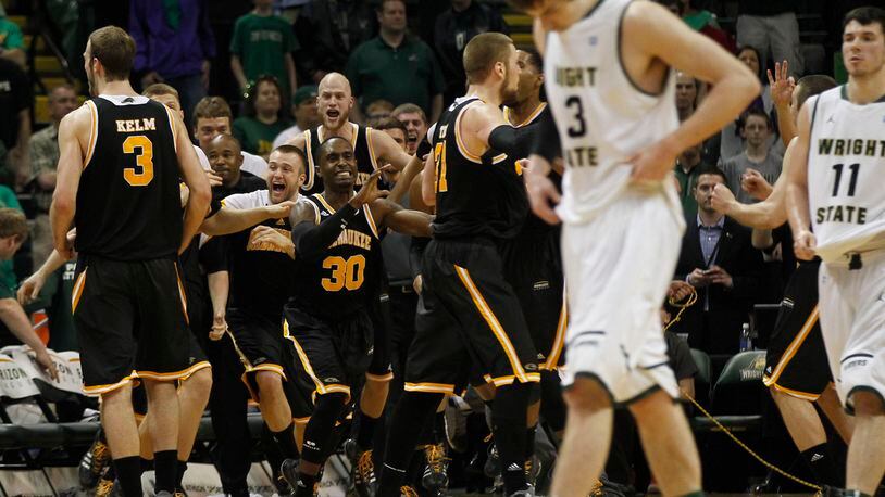 Milwaukee Panthers react as the clock ran out to defeat the Wright State Raiders 69-63 for the Horizon League Championship. Raiders Reggie Arceneaux and JT Yoho head for the locker room. TY GREENLEES / STAFF